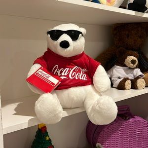 Coca Cola stuffed bear . Wearing sunglasses and red t-shirt.